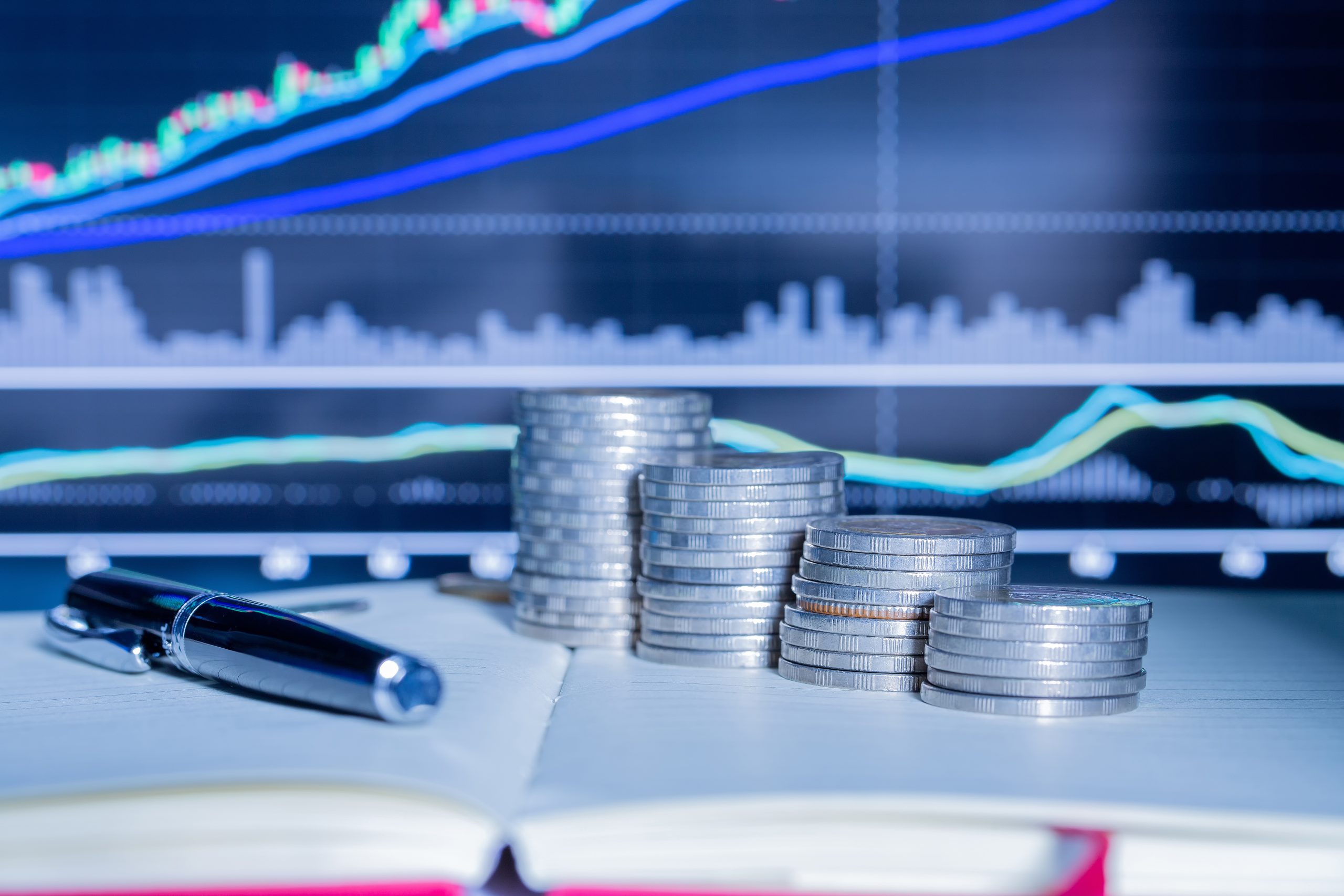 Stack of money coin with trading graph. financial investment concept use for background.